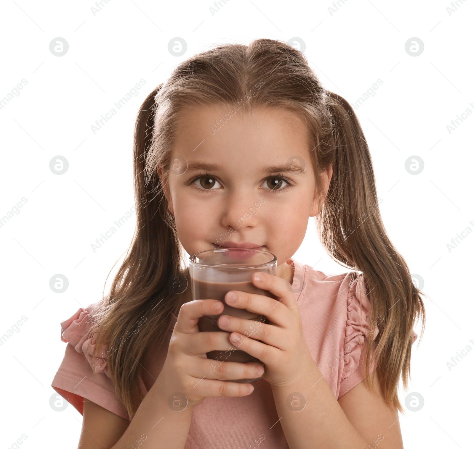 Photo of Cute little girl drinking chocolate milk on white background