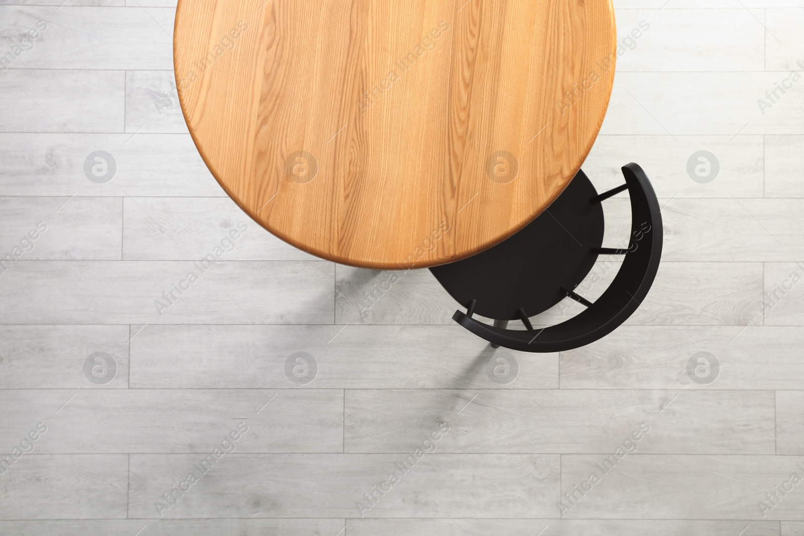 Photo of Empty wooden table and chair indoors, top view. Stylish furniture