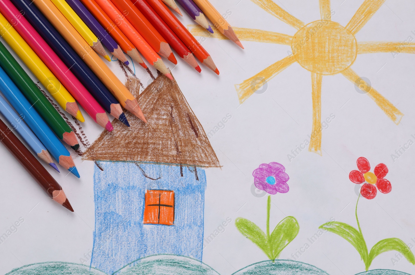 Photo of Cute child`s drawing and colorful pencils, flat lay
