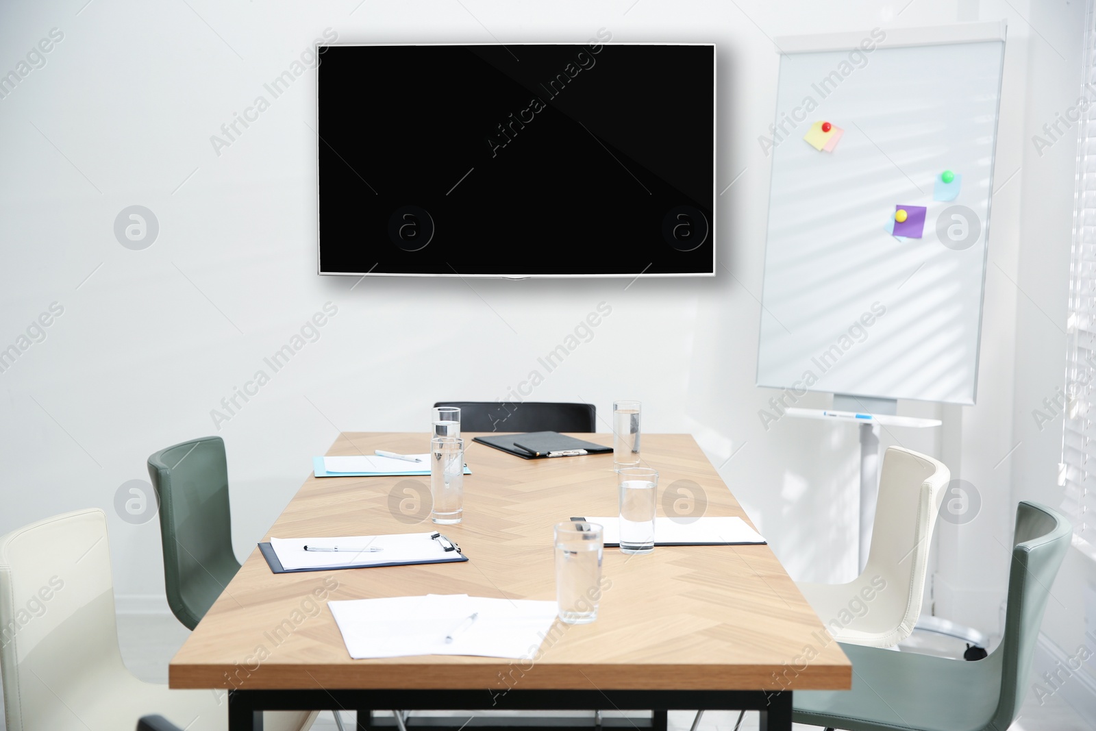 Image of Modern wide screen TV on white wall in conference room 