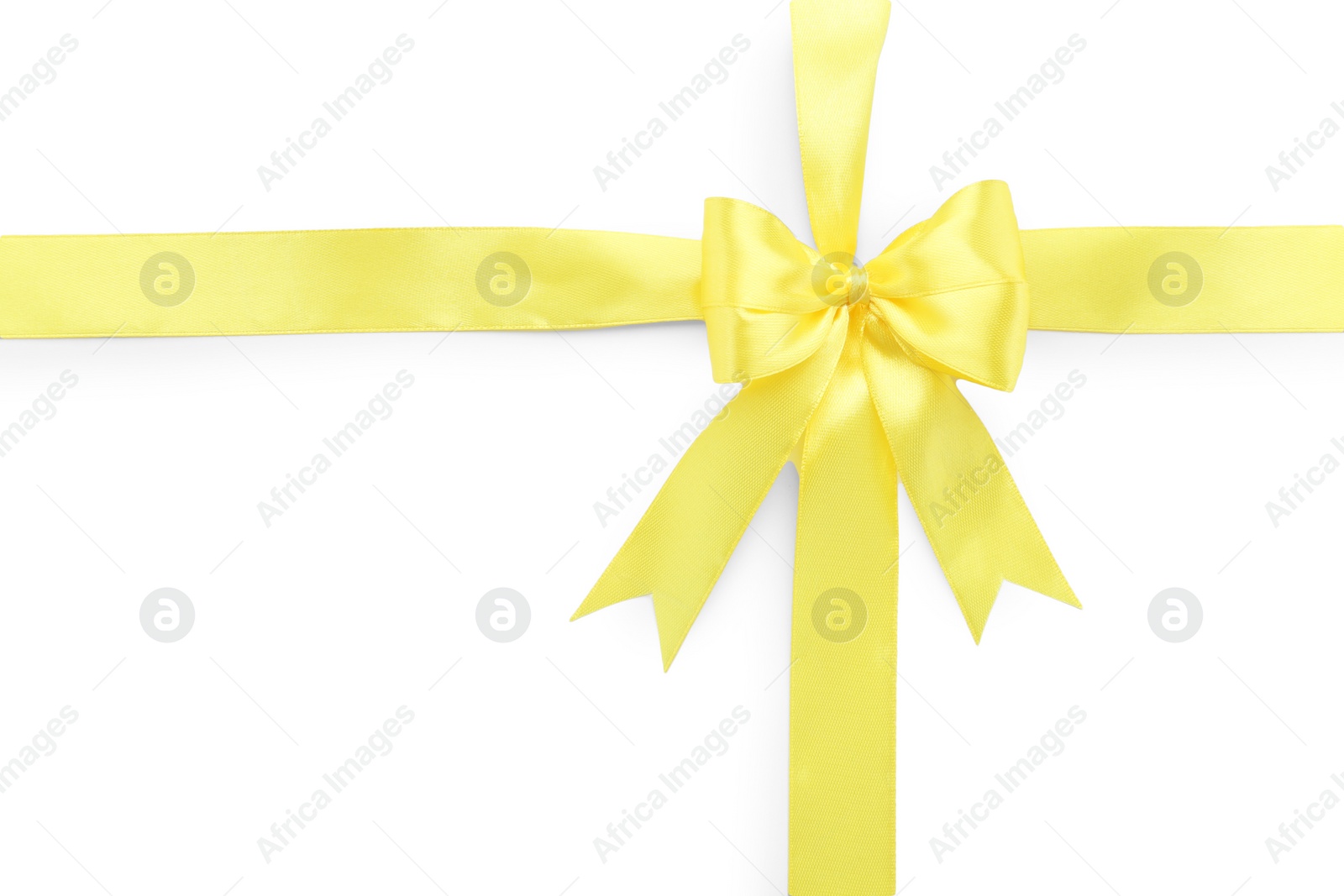 Photo of Yellow satin ribbon with bow on white background, top view