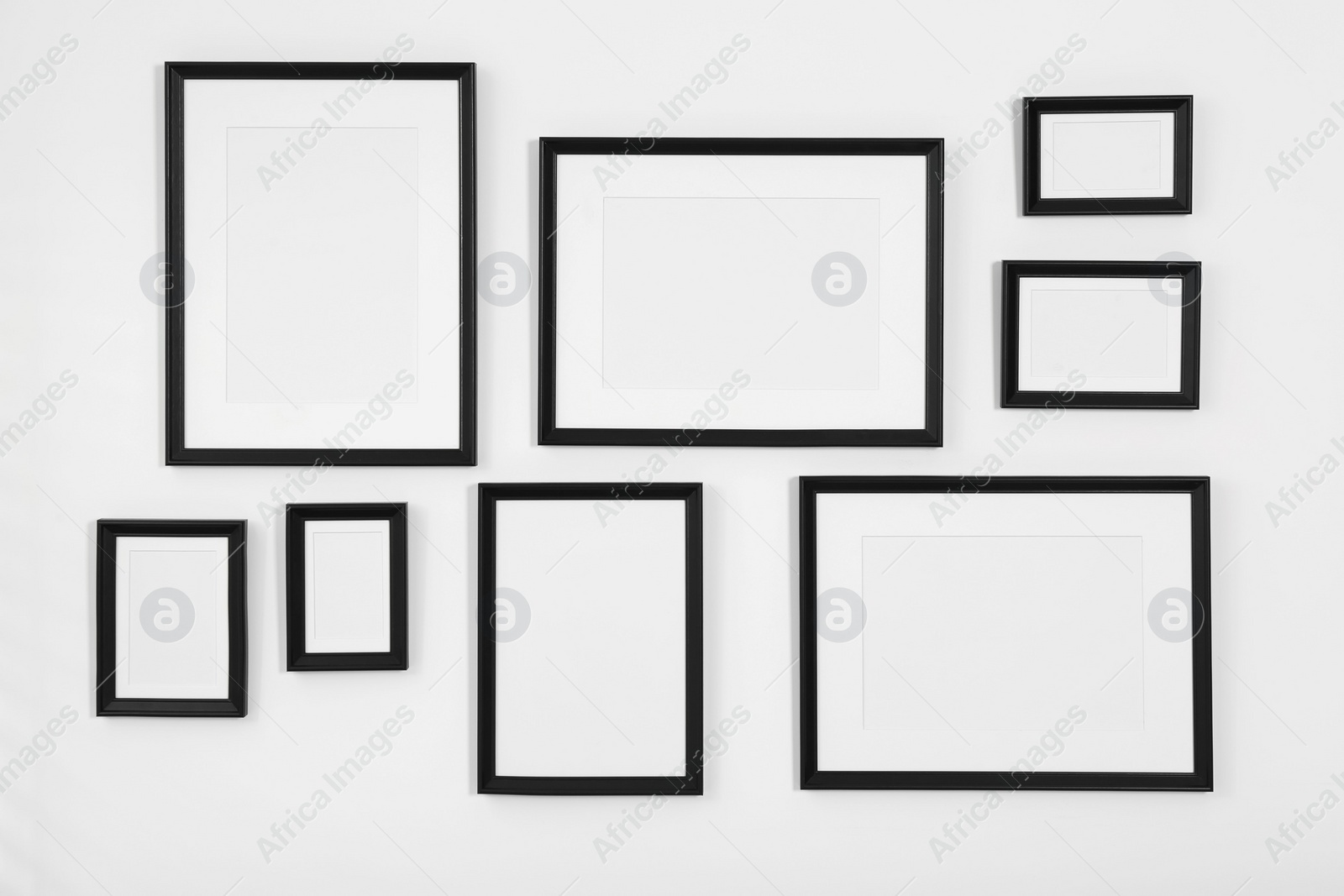 Photo of Empty frames hanging on white wall indoors