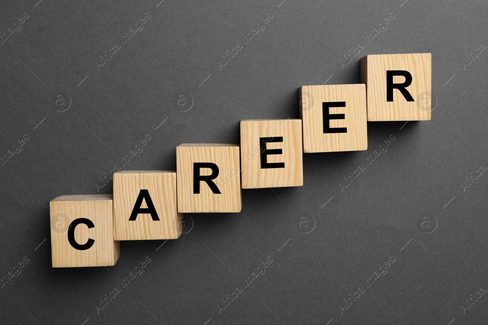 Photo of Wooden cubes with word CAREER on dark background, flat lay