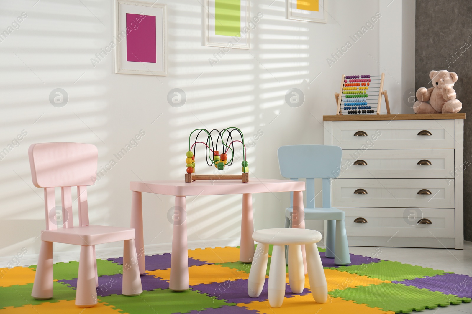 Photo of Stylish playroom interior with toys and modern furniture