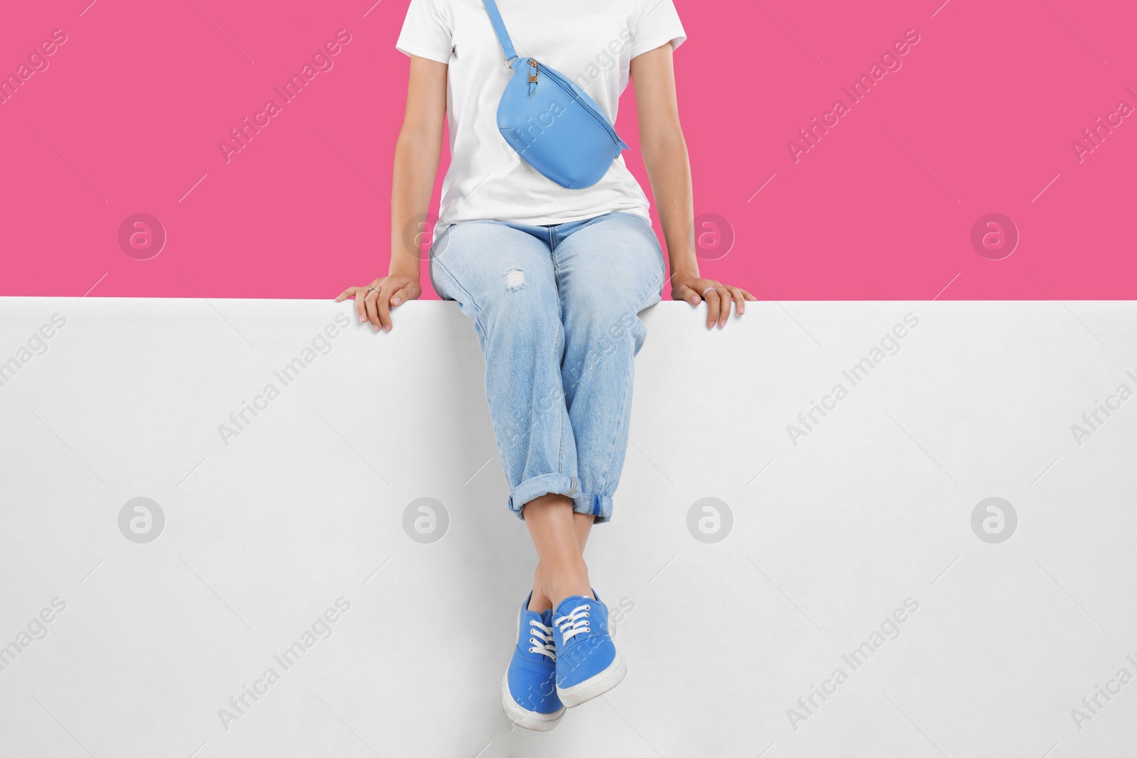 Photo of Woman wearing stylish shoes on color background, closeup