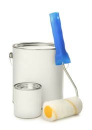 Photo of Paint cans and roller on white background