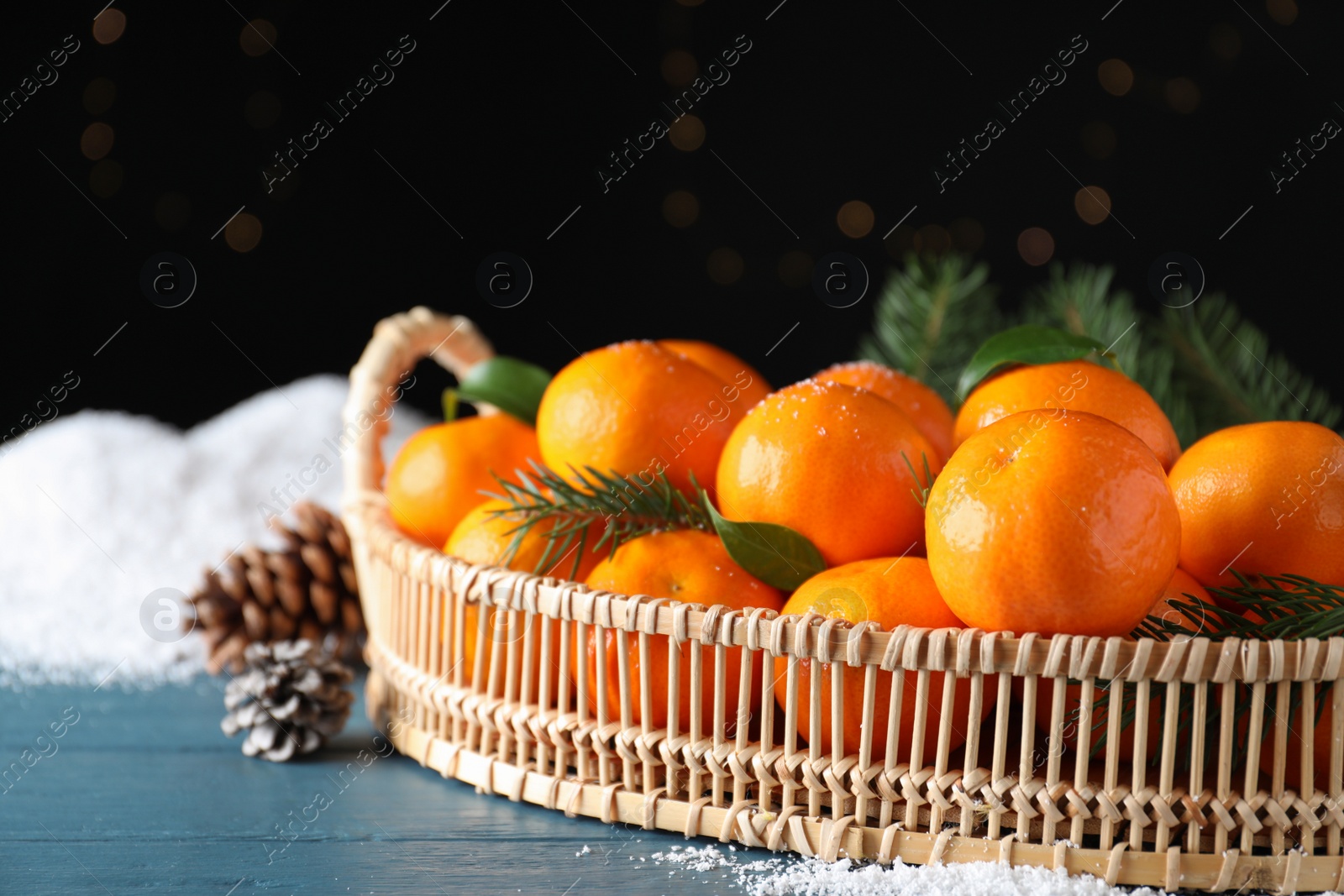 Photo of Tasty fresh tangerines on blue wooden table. Christmas celebration