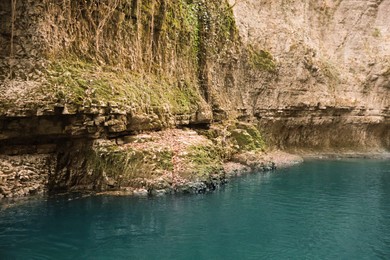 Photo of Picturesque view of clean river near cliffs outdoors