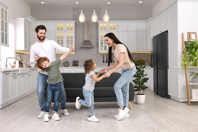 Photo of Happy family dancing and having fun at home