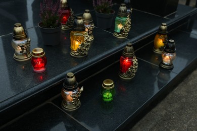 Photo of Grave lights on granite surface at cemetery