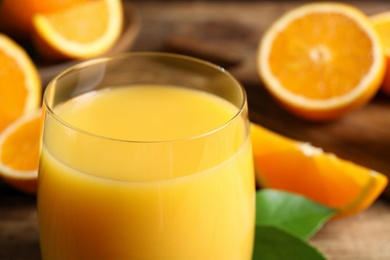 Photo of Glass of delicious fresh orange juice, closeup