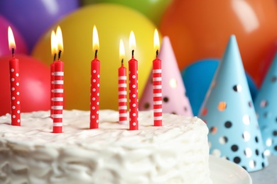 Photo of Delicious birthday cake with burning candles, closeup