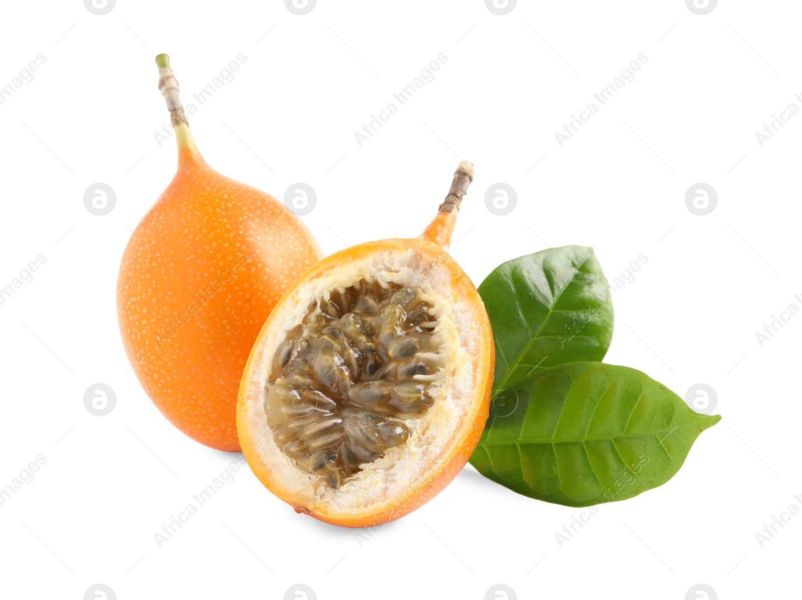 Photo of Whole and cut delicious ripe granadillas with green leaves on white background