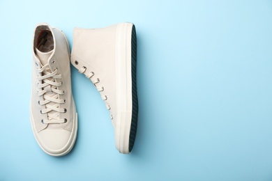 Photo of Pair of stylish sneakers on color background, top view