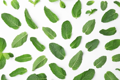 Flat lay composition with fresh green mint leaves on white background