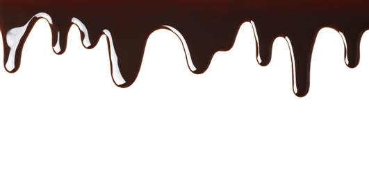 Delicious melted chocolate flowing on white background