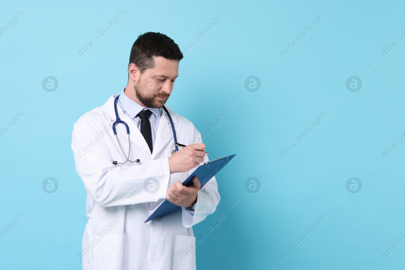 Photo of Doctor with clipboard and stethoscope on light blue background. Space for text