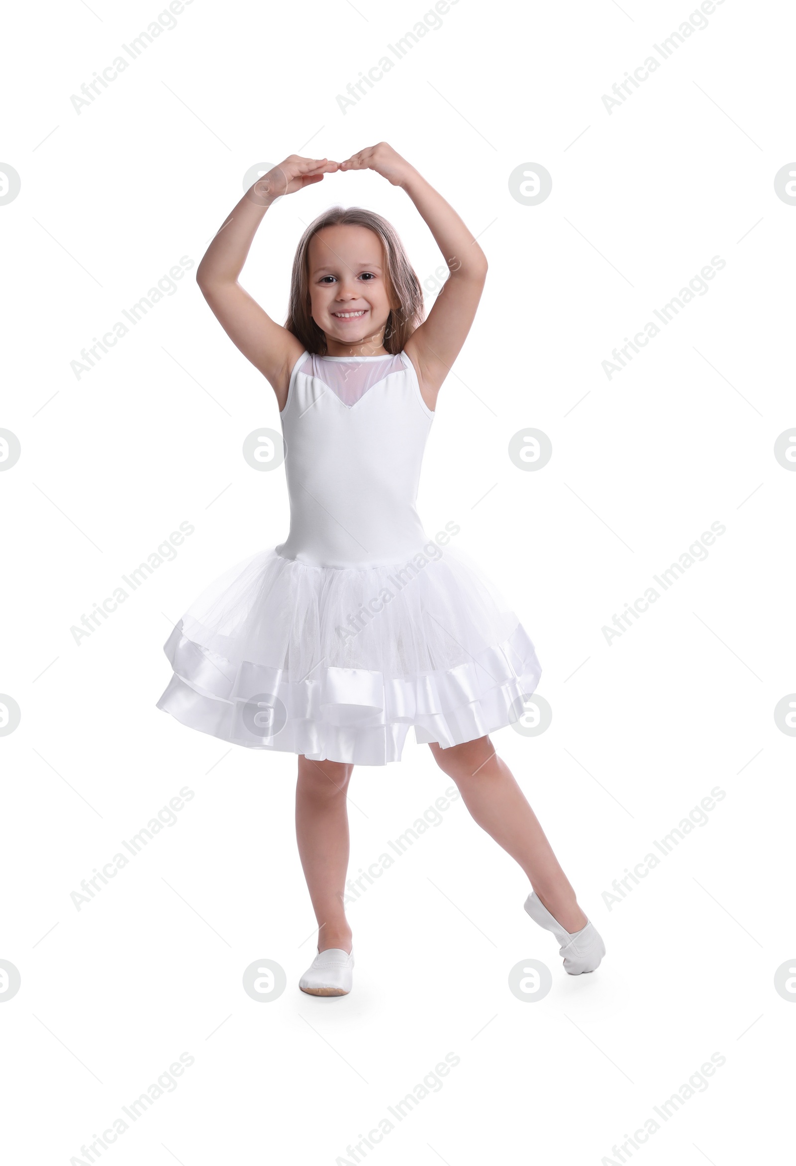 Photo of Cute little girl in beautiful dress dancing on white background