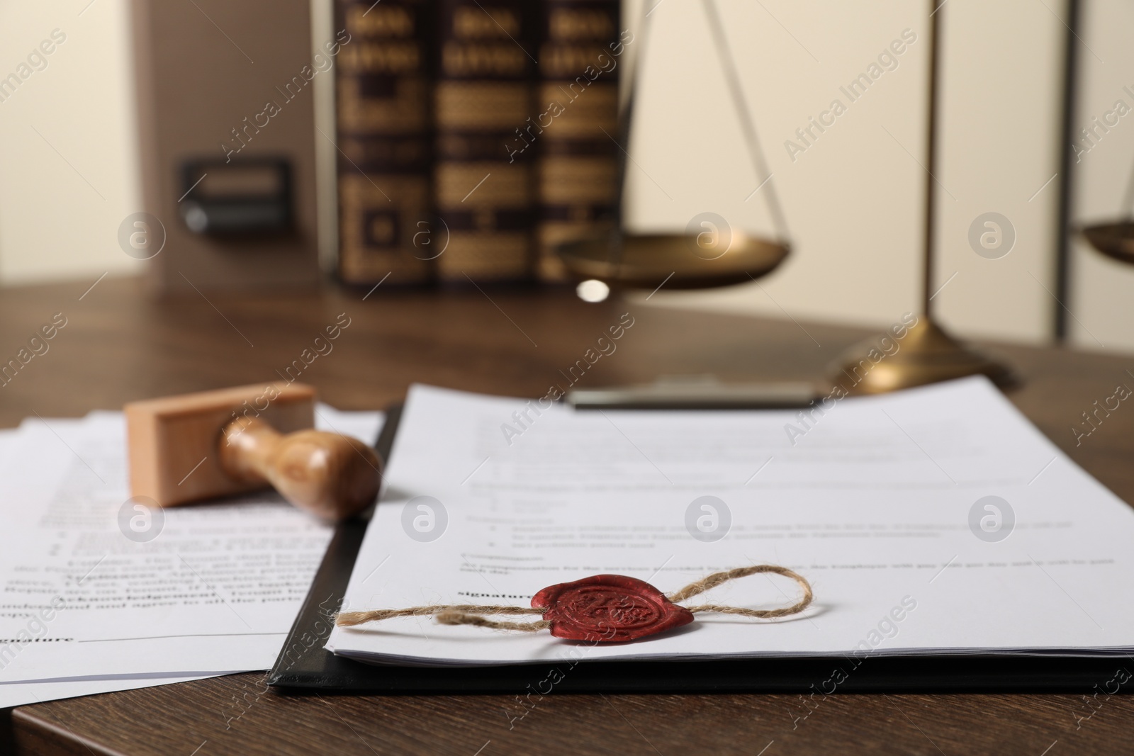 Photo of Documents and stamp on wooden table, closeup. Notary contract