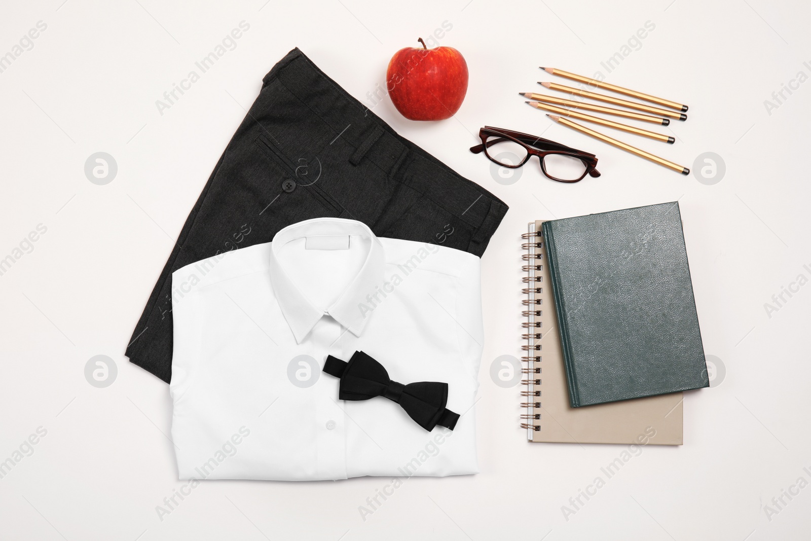 Photo of School uniform for boy and stationery on white background, top view