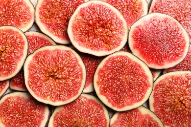 Photo of Pieces of fresh ripe figs on table, top view