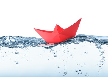 Image of Handmade red paper boat floating on clear water against white background 