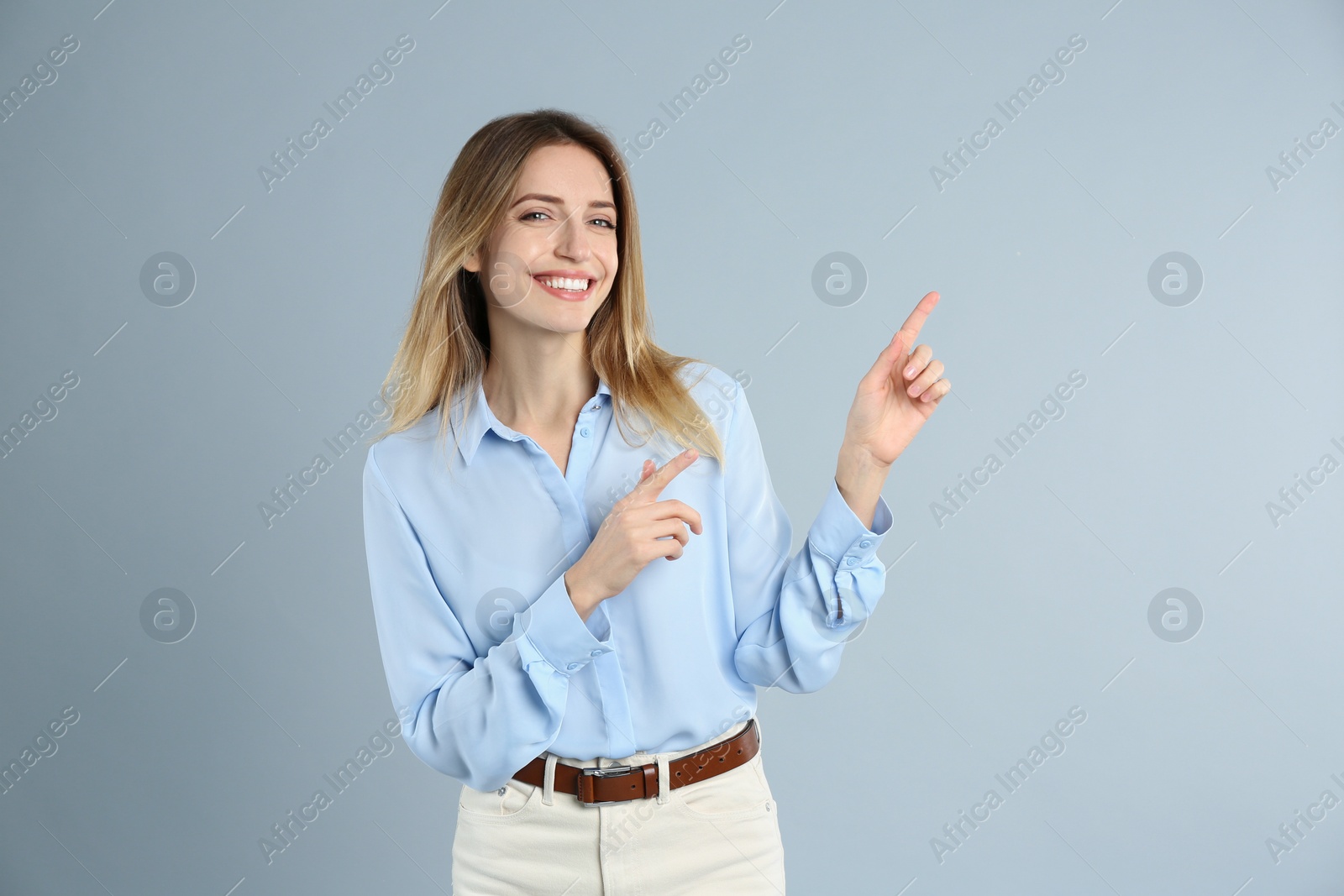 Photo of Portrait of beautiful young businesswoman on light grey background