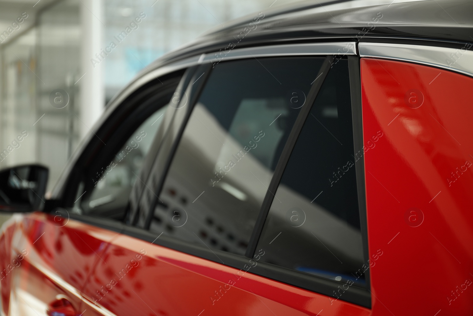 Photo of Modern car with tinting foil on window, closeup