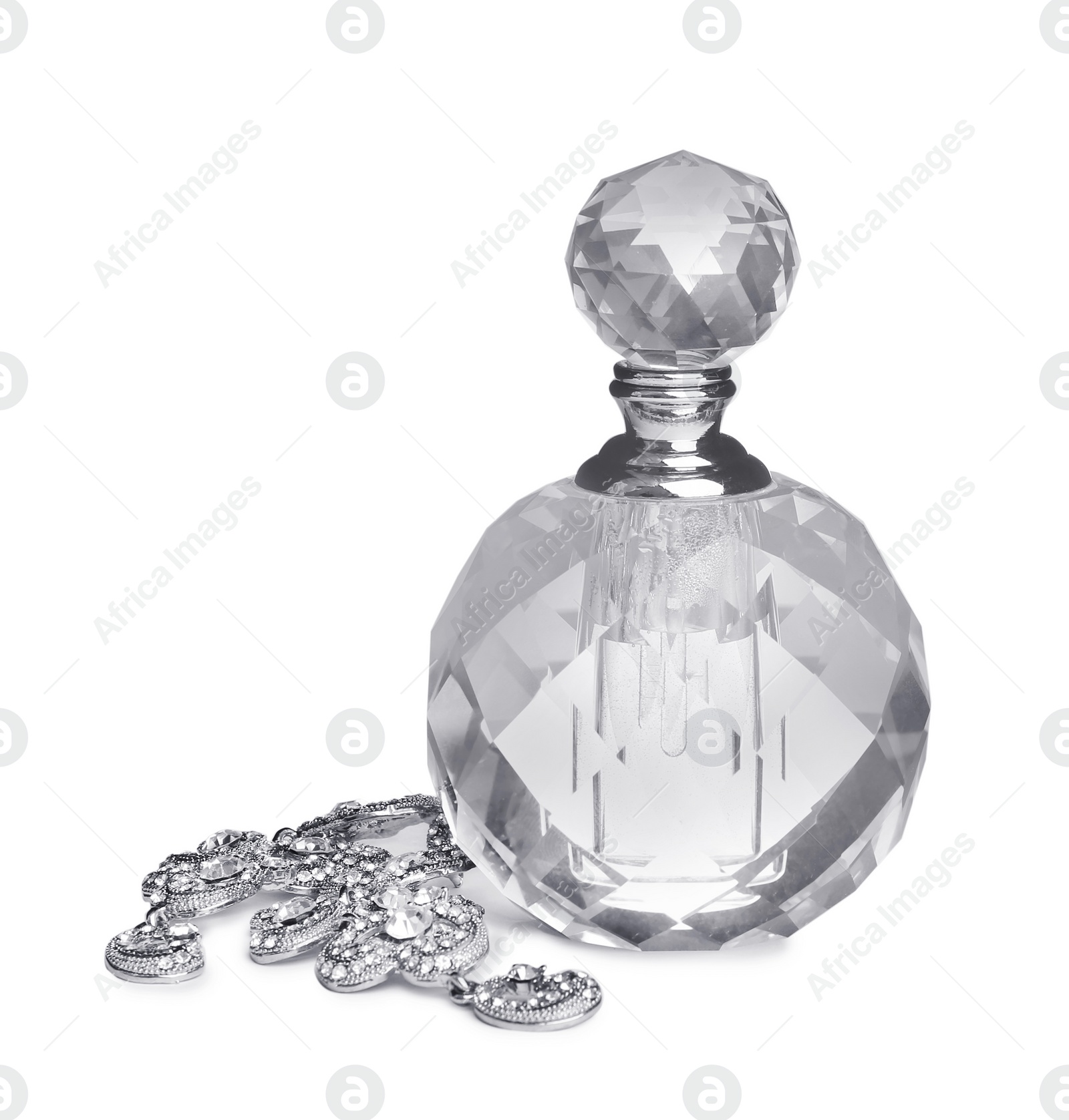 Photo of Glass bottle of perfume and luxury jewellery isolated on white