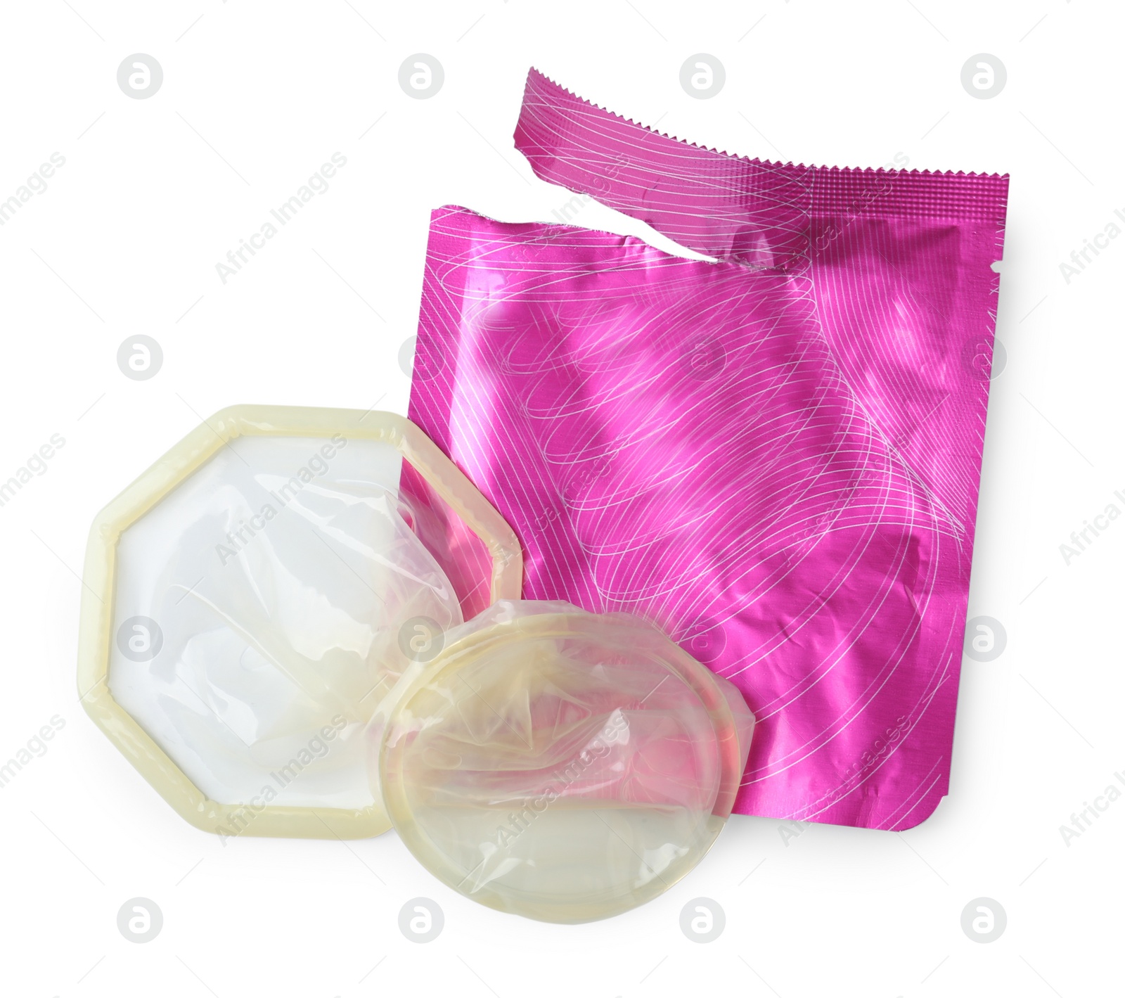 Photo of Unpacked female condom and torn package isolated on white, top view. Safe sex