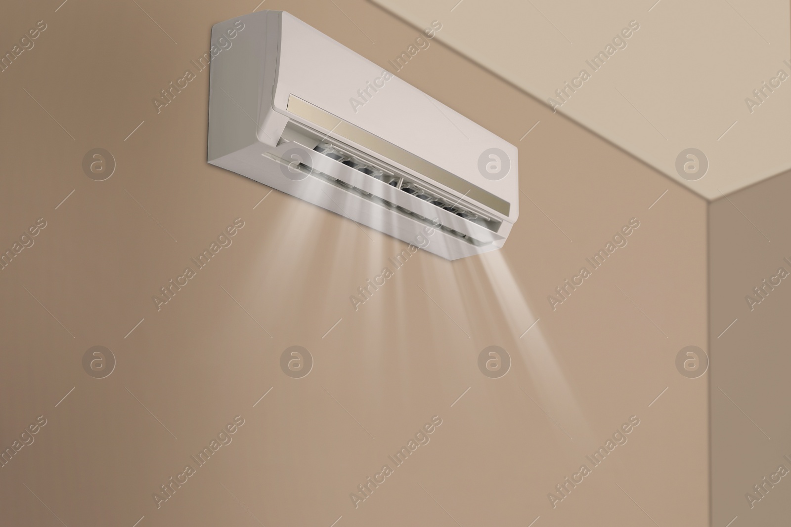 Image of Modern air conditioner on beige wall indoors