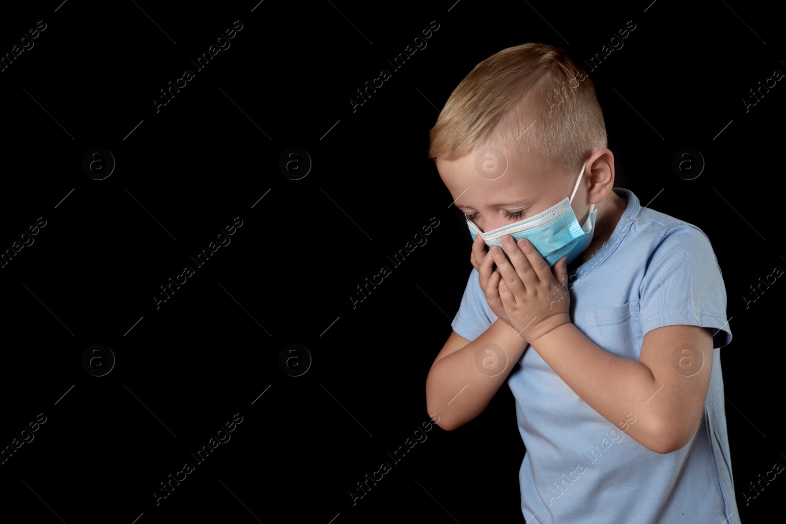 Photo of Little boy in medical mask on black background, space for text. Virus protection