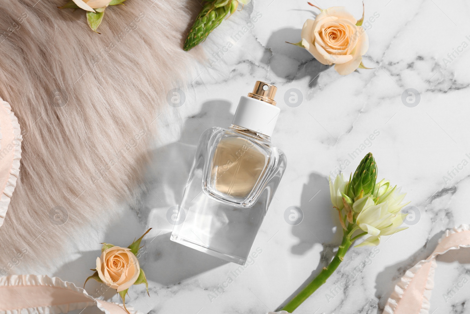 Photo of Beautiful composition with bottle of perfume on light background, flat lay