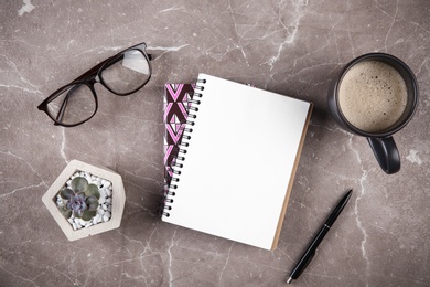 Photo of Flat lay composition with office stationery and cup of coffee on marble table. Space for design