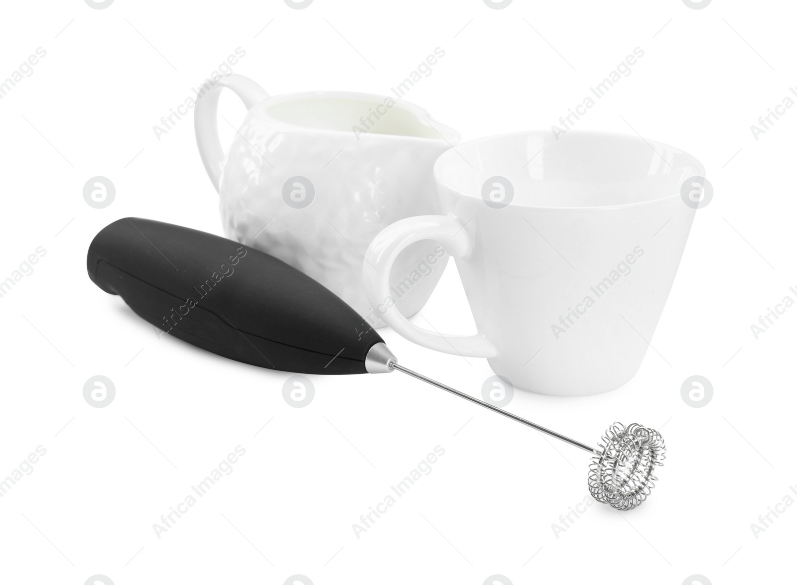 Photo of Milk frother wand, cup and pitcher isolated on white