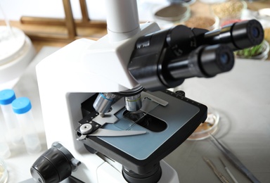 Photo of Modern microscope on table in laboratory. Phytopathological analysis