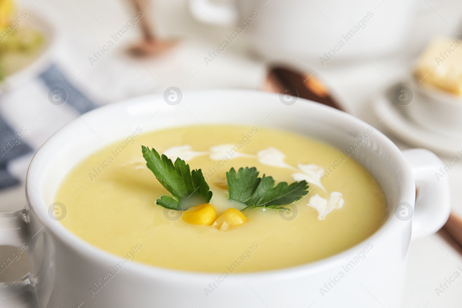 Photo of Delicious corn cream soup in bowl, closeup