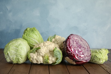 Different sorts of cabbage on wooden table