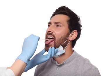 Photo of Doctor examining man`s oral cavity with tongue depressor on white background