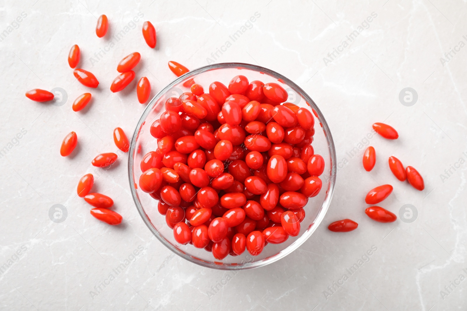 Photo of Fresh ripe goji berries on marble table, flat lay