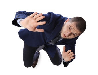 Photo of Man in suit evading something on white background, above view
