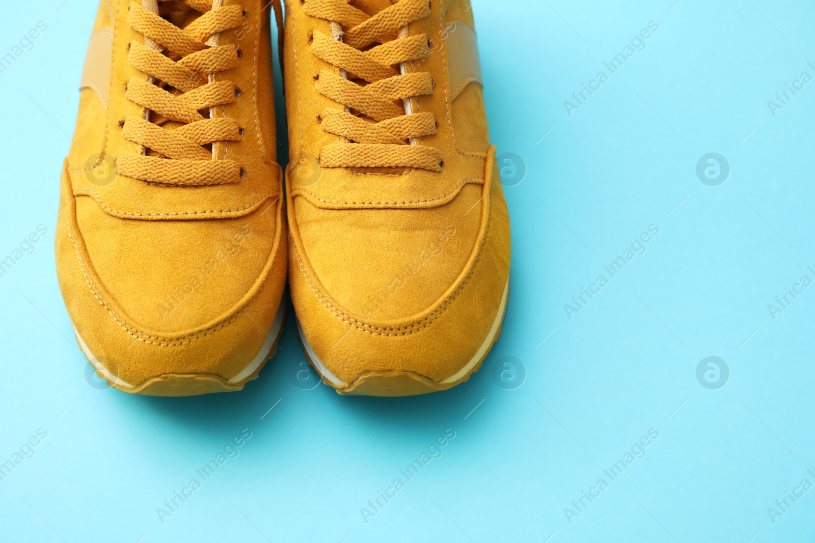 Photo of Pair of stylish shoes on light blue background