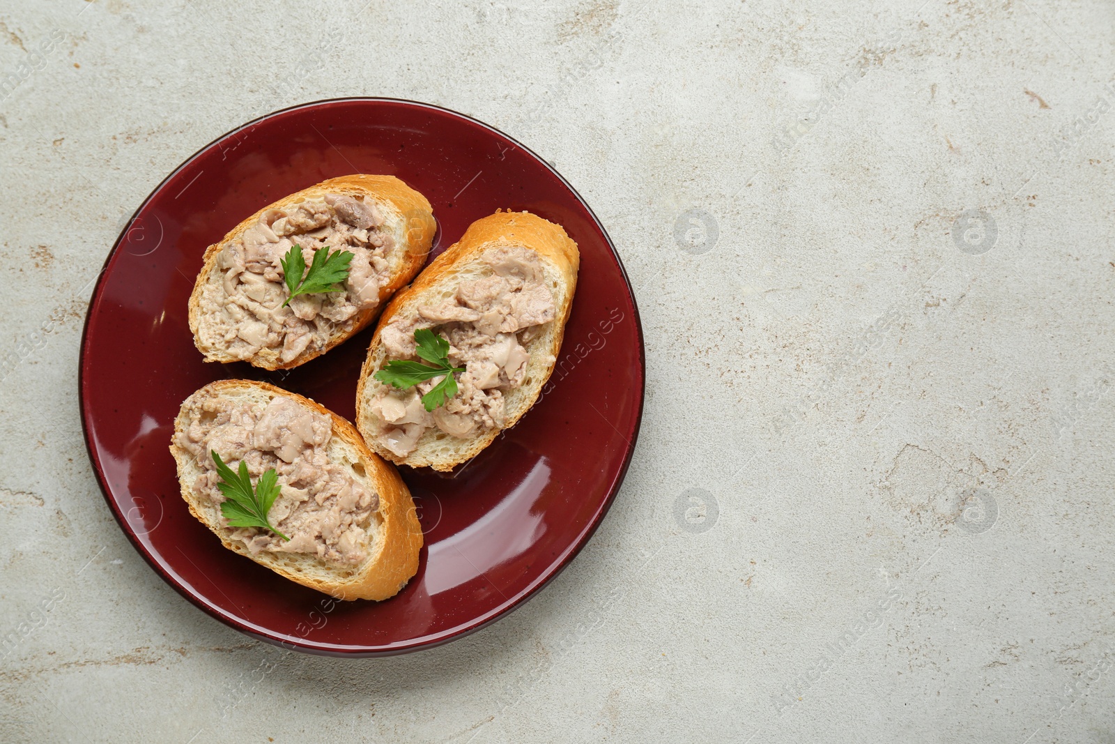 Photo of Tasty sandwiches with cod liver on light grey table, top view. Space for text