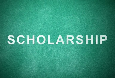 Word SCHOLARSHIP written with chalk on green chalkboard