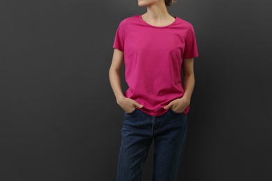 Photo of Woman in bright t-shirt on dark background. Mock up for design