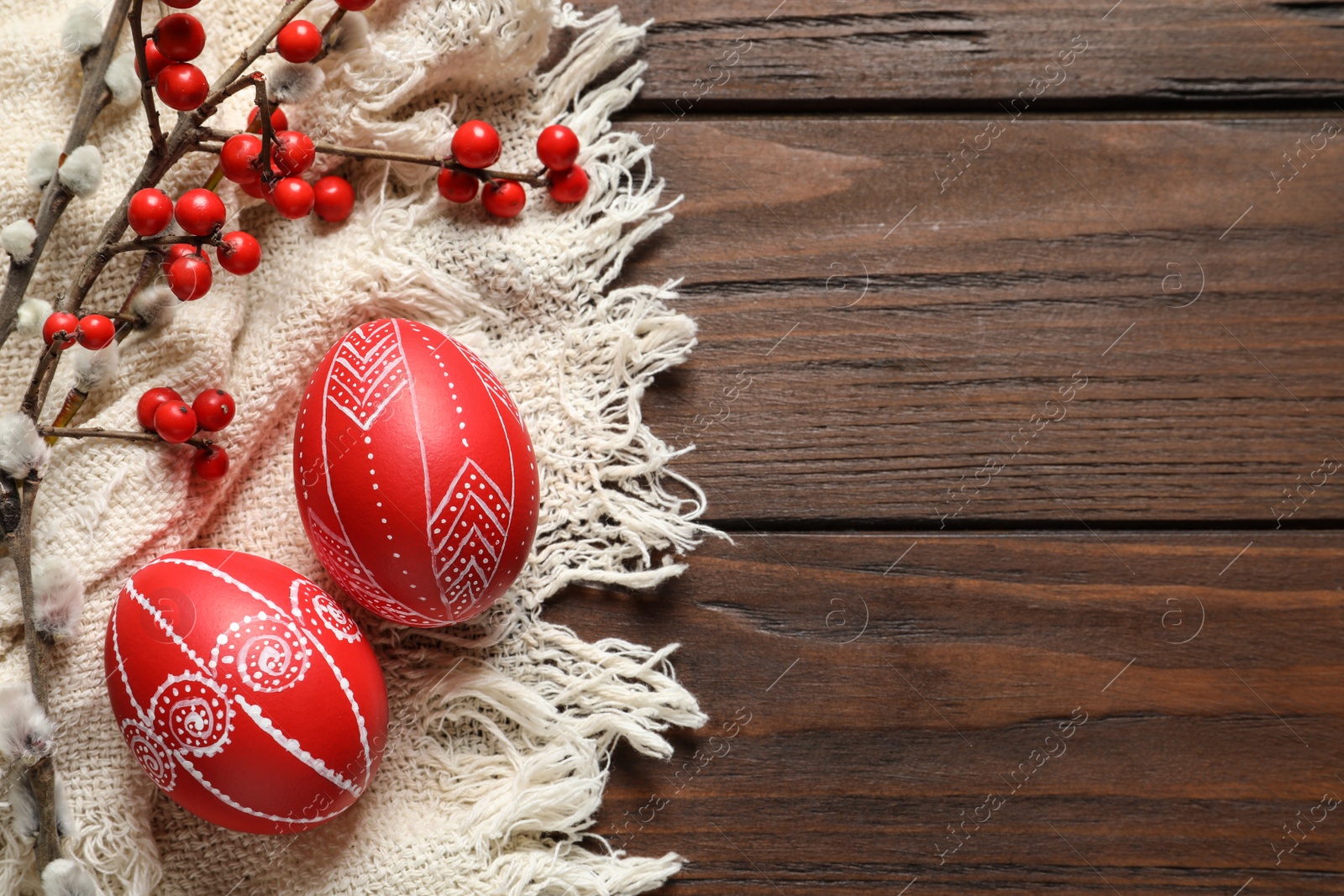 Photo of Flat lay composition with painted red Easter eggs on wooden table, space for text