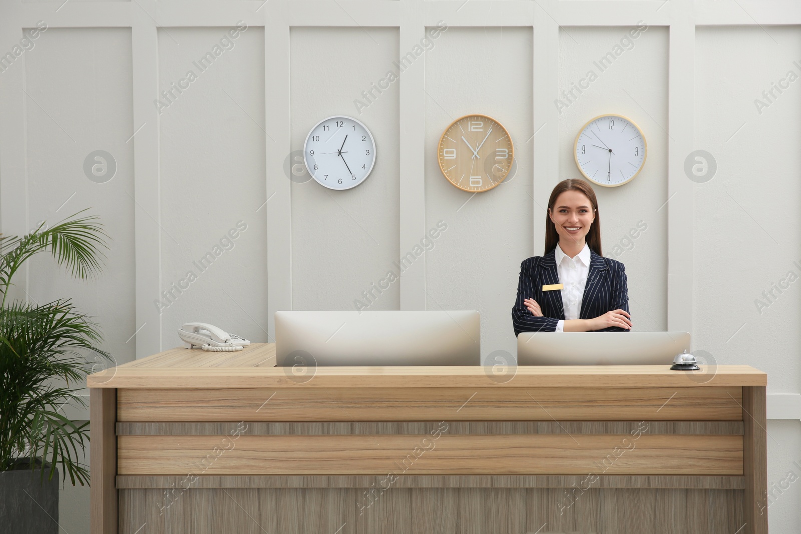 Photo of Portrait of beautiful receptionist at counter in hotel