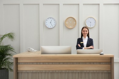 Photo of Portrait of beautiful receptionist at counter in hotel