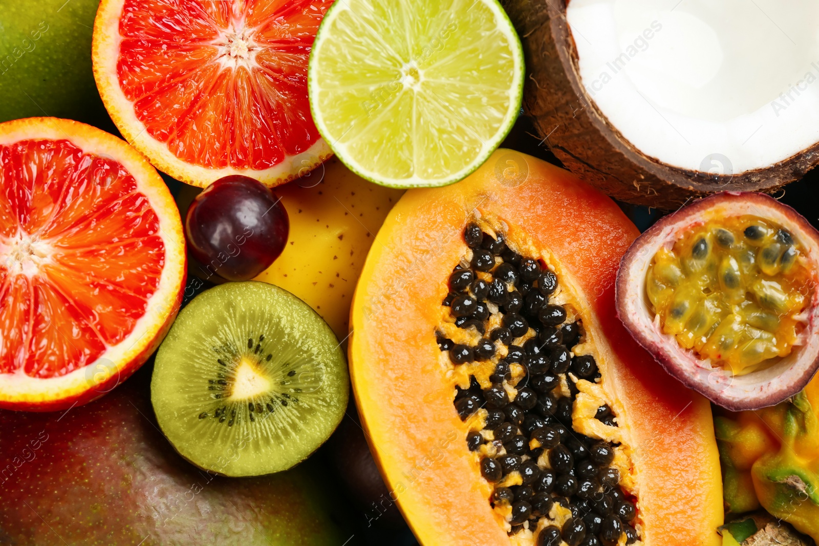 Photo of Many different delicious exotic fruits as background, closeup