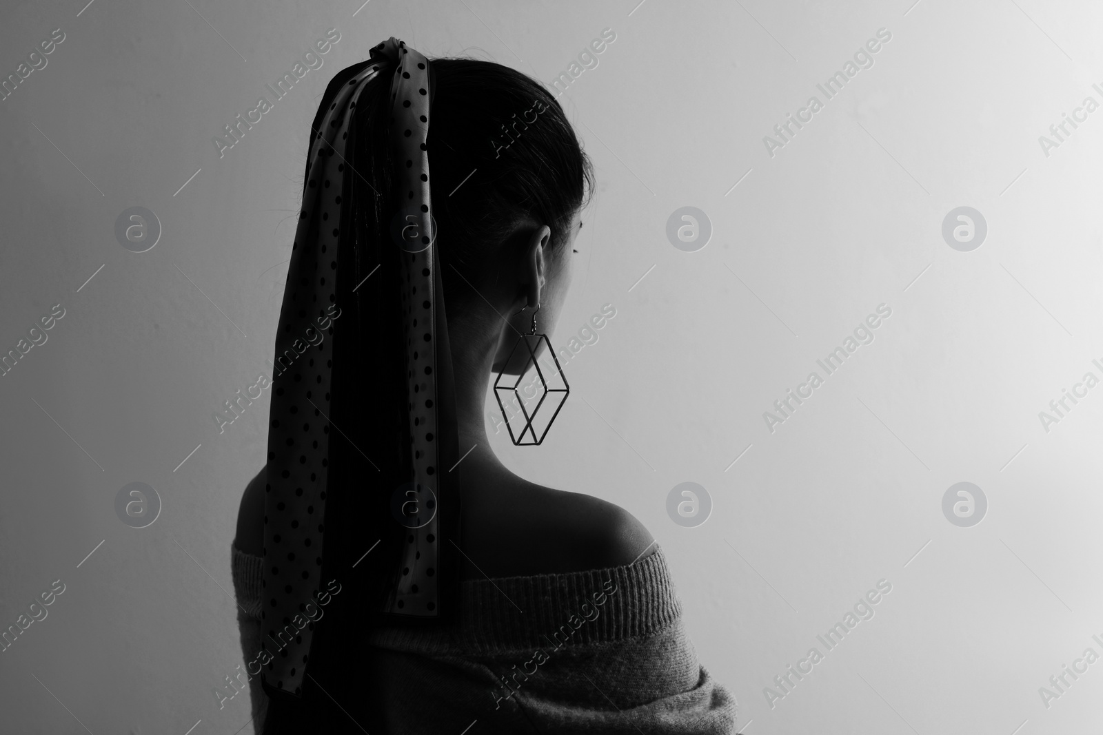 Image of Silhouette of one woman on light grey background, space for text